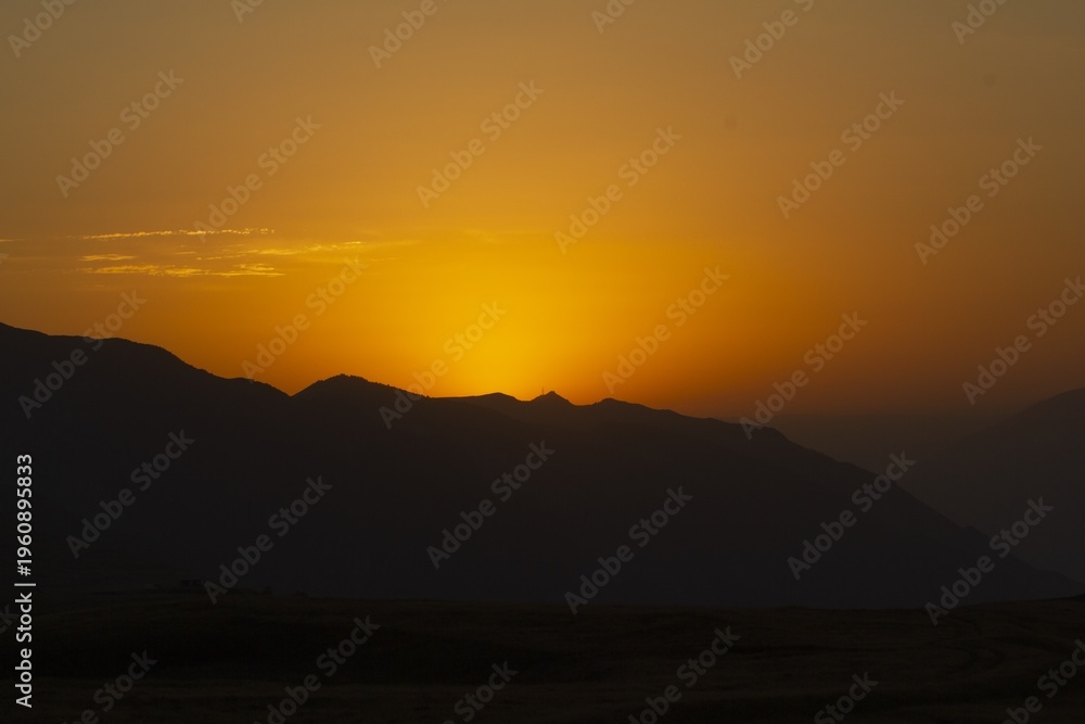 Fototapeta premium Sunset Over Mountainous Terrain