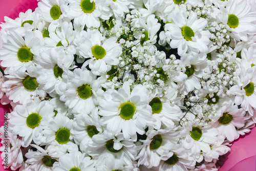 Beautiful bouquet of white chrysanthemums and gypsophila. Composition of many colorful fragrant flowers. Floristry and floral design concept. Floral texture.