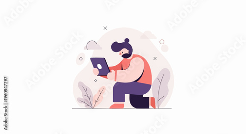 A person with a beard and bun hairstyle kneels using a tablet device outdoors