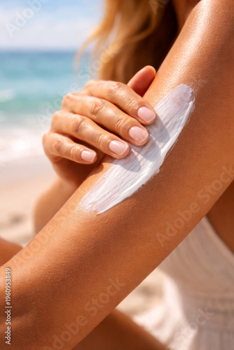 Applying sunscreen on tanned skin at beachside relaxation