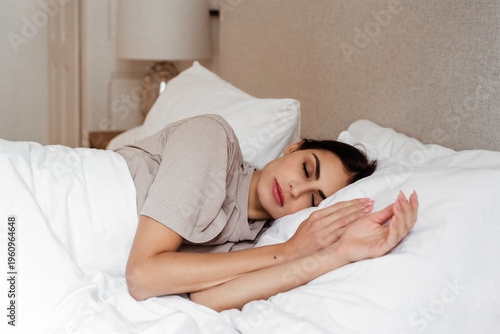 Young woman sleeping in comfortable bed at home, healthy rest and relaxation