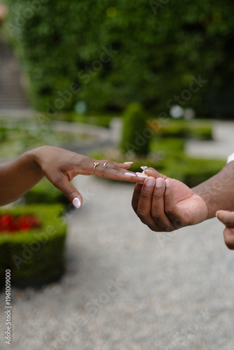 Intimate Garden Promise: Hands Entwined in a Moment of Commitment