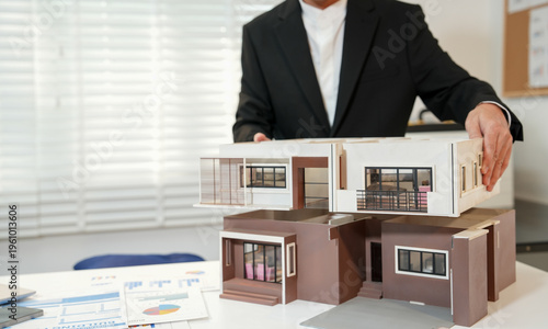 Canvas Print A real estate agent handles rentals or purchases of homes