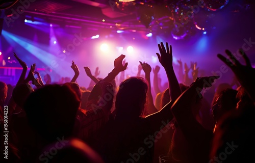Dancing as a group of friends during a live performance of electronic music at a nightclub
