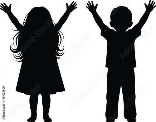 Black silhouette of a little girl and boy standing with hands raised in joy, childhood happiness, success, freedom, and friendship.