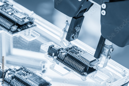 Fotografie Advanced automatic robotic system moving assembled circuit boards (PCB) on a high-tech production line in a smart factory