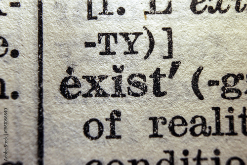 Photos Word exist printed on dictionary page, macro close up