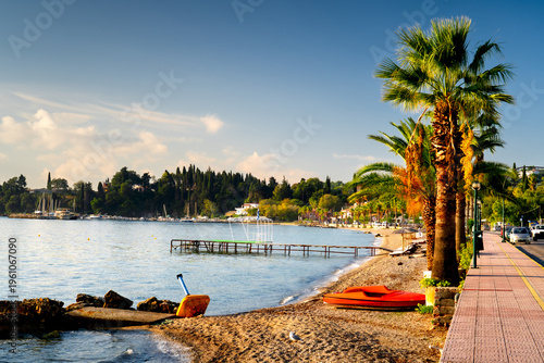 Promenade with palm trees in morning light on island Corfu, Greece, Kato Agios Markos.
