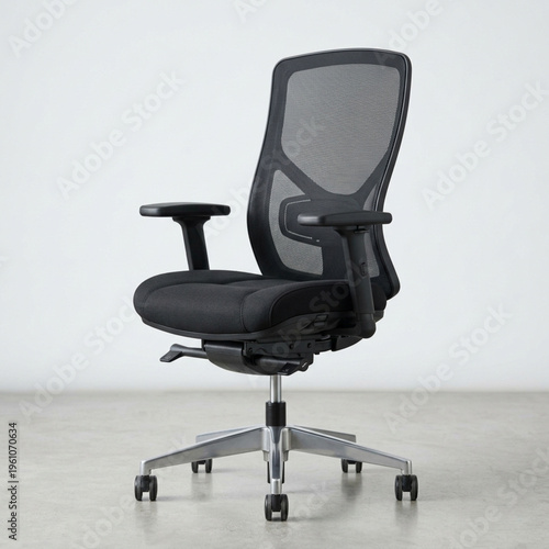 A modern black ergonomic office chair with a mesh back and padded seat is shown in a studio setting