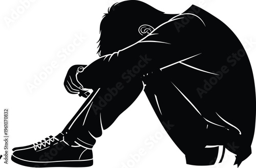 Black silhouette of a lonely sad boy sitting on the ground with head down feeling depressed isolated on white background