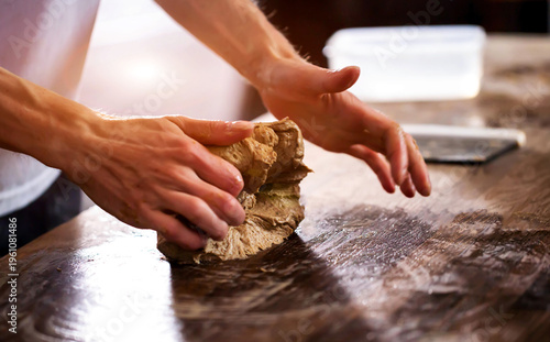 Person hands kneading dough on wooden table preparing bread for baking baking process preparation of artisan whole grain bread close up of cooking ingredient