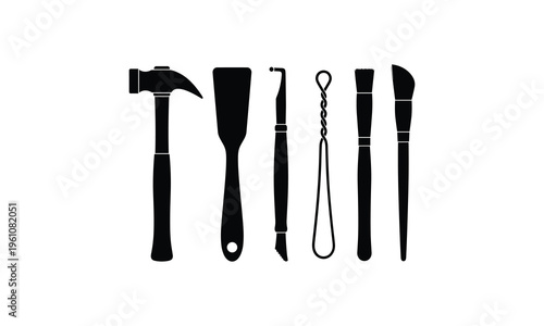 Assorted black and white silhouettes of classic hand tools and crafting implements