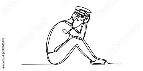 sad young woman sitting alone with head in hand