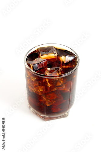  There is a glass with ice and cola on a white background.
