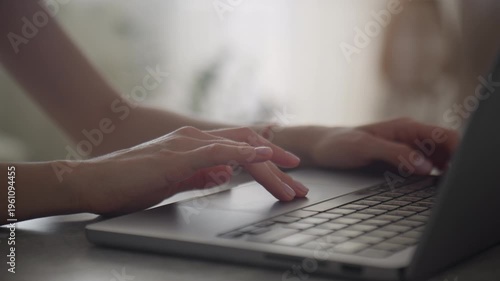Hand Using Laptop Trackpad at Desk