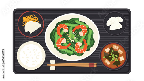 Healthy Japanese meal set featuring a plate of stir fried shrimp and green vegetables served with white rice and miso soup.