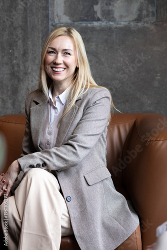 Smiling Professional Business Woman Sitting on Sofa in Modern Office Casual Meeting Portrait