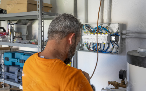 Wallpaper Mural Professional electrician setting up domestic power system inside a modern home under construction Torontodigital.ca