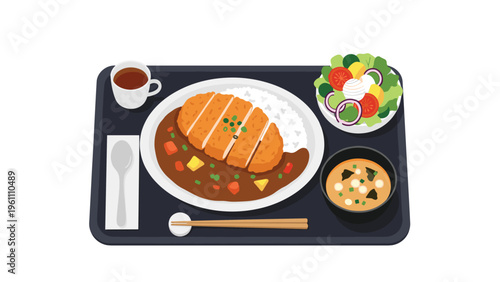 Japanese curry rice with crispy breaded pork cutlet served as a complete meal with miso soup, garden salad, and hot tea.
