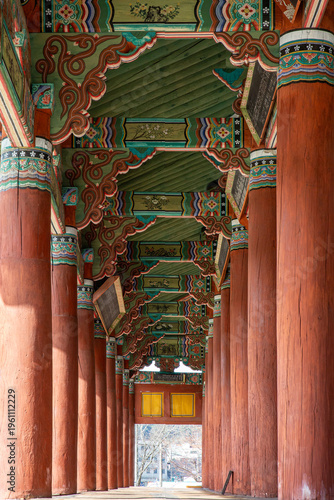 Traditional Korean hanok architecture with colorful dancheong patterns and wooden pillars showcasing detailed heritage design and interior structure.
