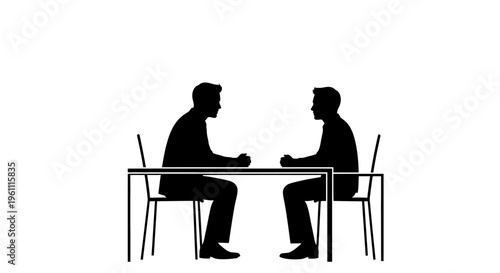 Two men sitting at table talking.