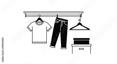 A white t-shirt and dark jeans are hanging on a clothes rail with an empty hanger and a box.