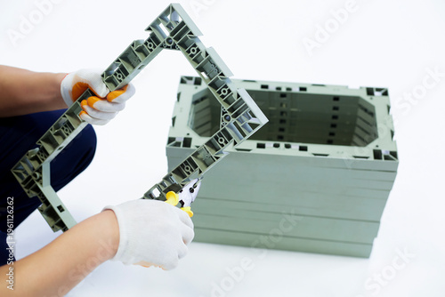 Wearing white gloves to install plastic picture frames