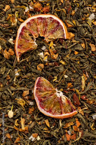 tea with added flavors and pieces of fruit and cut dried red oranges, bright large dry slices of blood red orange and green tea with pieces of fruit
