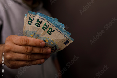 Hand holding twenty euro ba...