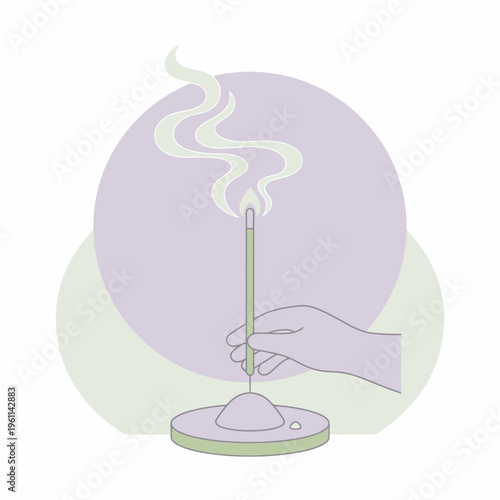Hand holding burning incense stick with smoke rising.