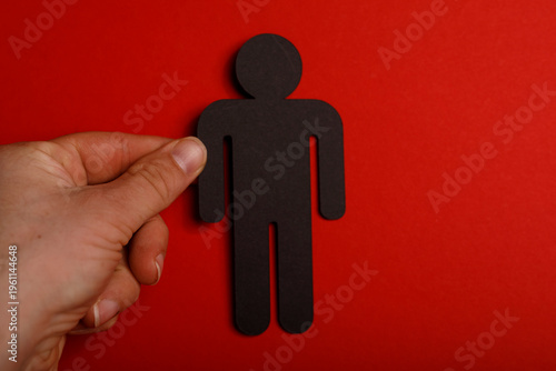Hand holding a black human ...