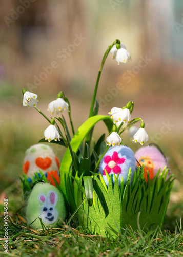 easter eggs in the grass in a green basket