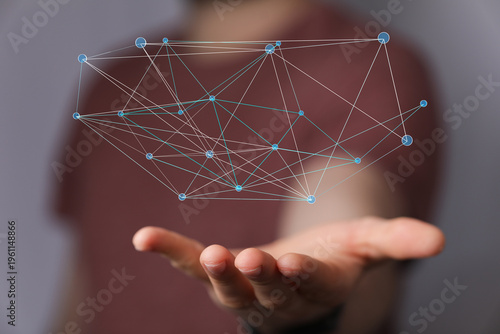 Man's hand holding a glowing network graph. Representing digital connectivity, communication, and data. Suitable for IT,
