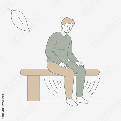 Man sitting on bench looking down with leaf nearby.