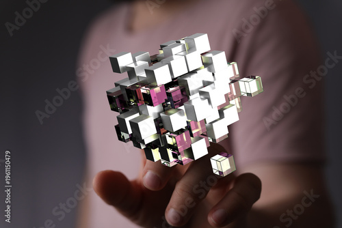 Abstract and futuristic image of a hand interacting with a 3D geometric structure representing connectivity and digital