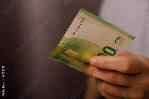 Hand holding one hundred eu...