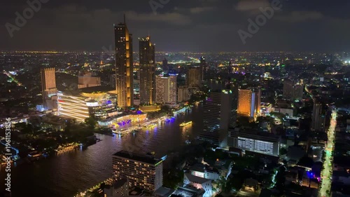 24 March 2026 Night views of Neon Light colouful Cruise Boats on Chao Phraya River with Icon Siam and BKK City illuminated with colourful lights, viewed from Lebua Sky Bar in BKK Bangkok Thailand