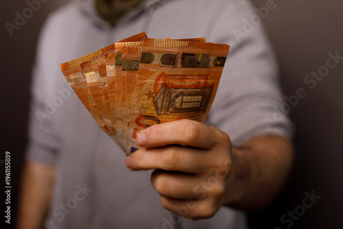 Person holding Euro banknot...
