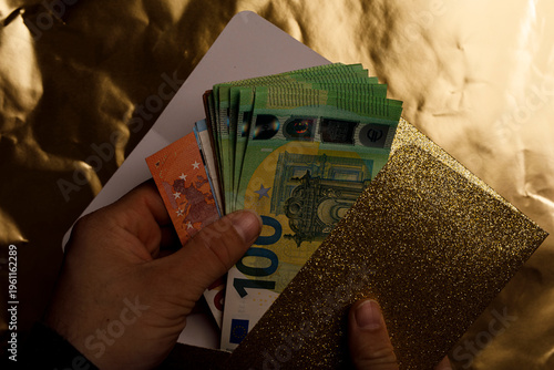 Close-up of hands with Euro...