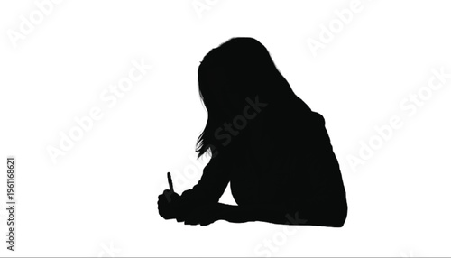 Shadow of a person sitting down and writing or drawing with a pen on an unseen surface below them.