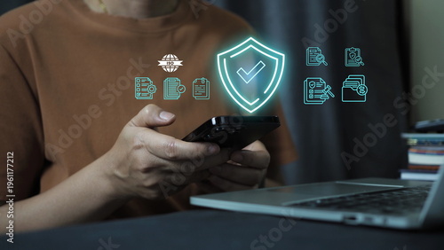 Data protection and cybersecurity concept with digital shield icon over document on laptop, representing information security, privacy protection, compliance, encryption, 