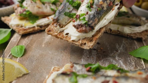 Sardines on crispbread with cream cheese and lemon dressing, healthy open sandwich