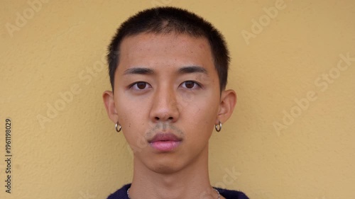 Happy teenager asian man smiling in front of camera outdoor - Culture, aisa and young person concept