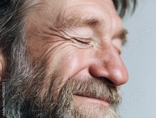 Close-up of a Smiling Elderly Man with Beard 