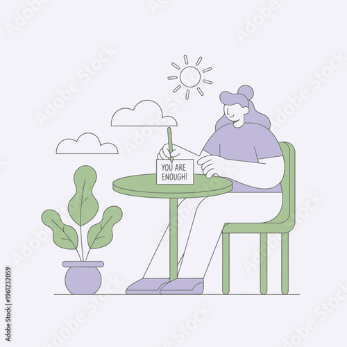 Woman sitting at table writing message of self-acceptance.