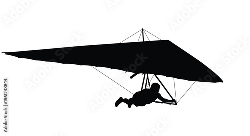 Black silhouette of a hang glider and pilot in flight silhouette