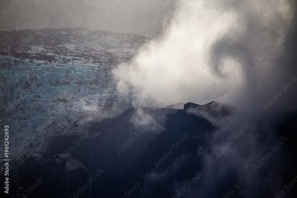 Fototapeta premium Spiraling clouds over blue ice glacier in Thorsmork Iceland artistic nature