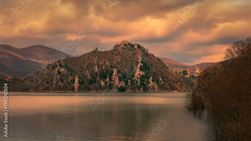 Photos Panoramic View of a Hilltop Town Reflected in Calm Lake Waters