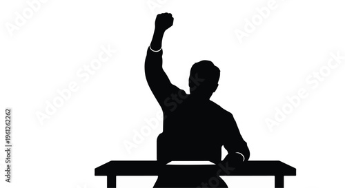 man sitting on table with fist raised in triumph