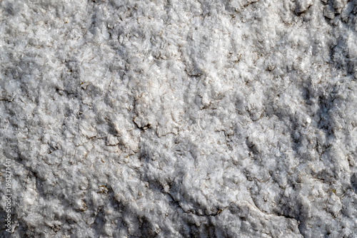 Close-up of white marble quartz rock texture with rough crystalline surface and natural stone pattern